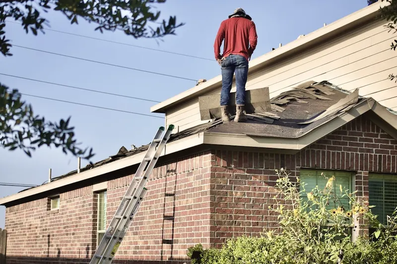 Professional roofer working on a residential roof in Broadway Square